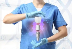 A person in blue scrubs and gloves holds a glowing dental implant hologram between hands. The background features hexagonal patterns and a clinical setting.