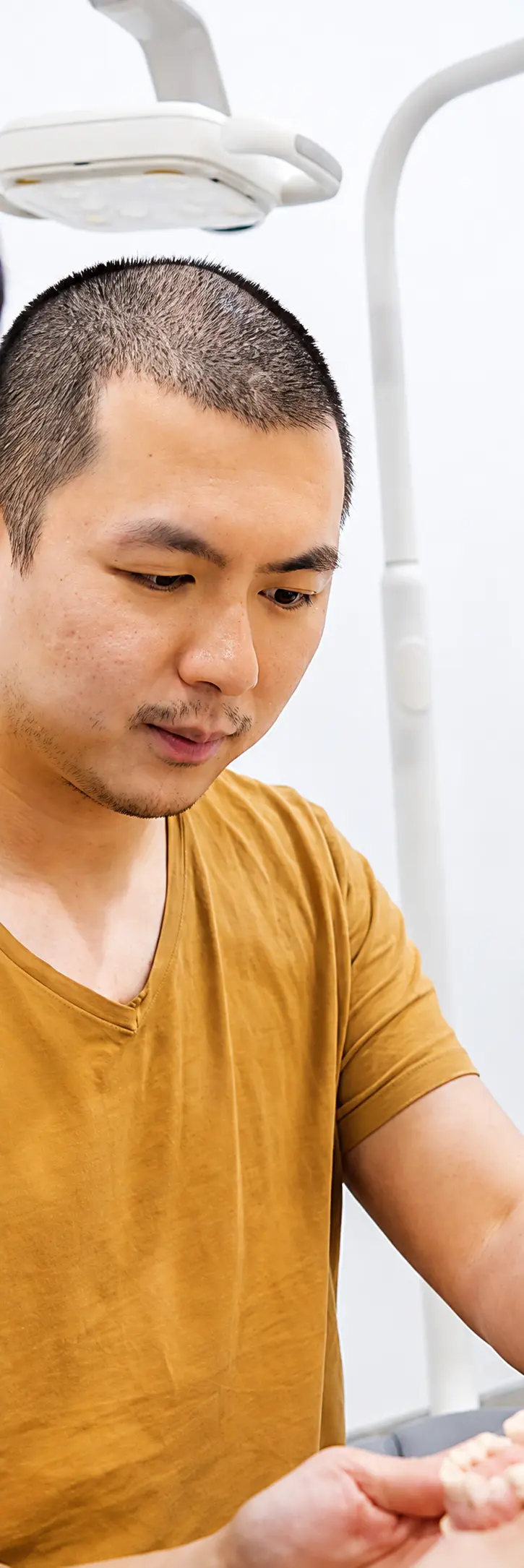 A male patient discussing dental treatment options and recommendations with his dentist in a modern clinic environment.